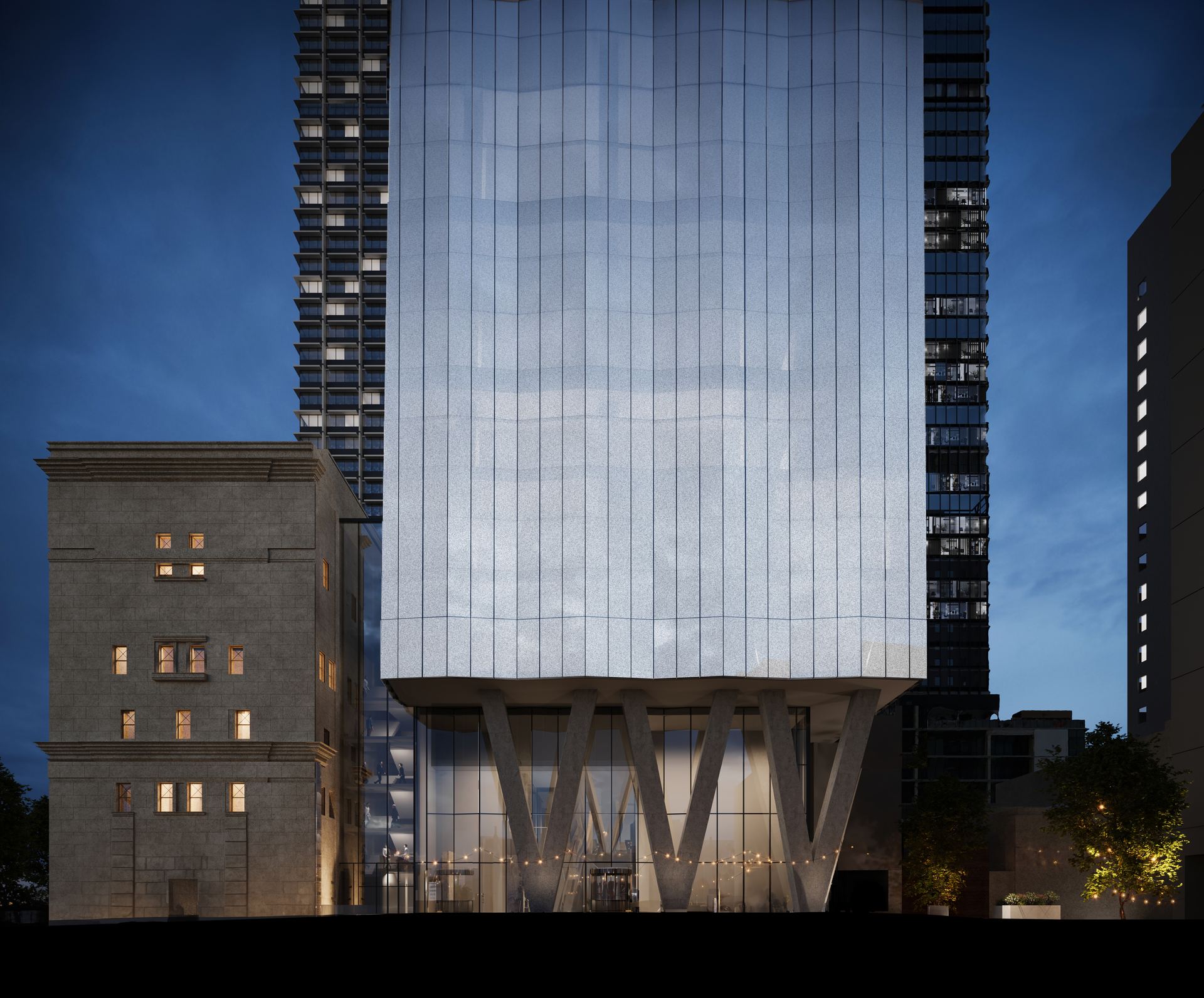 Glass tower rising above a heritage building at dusk